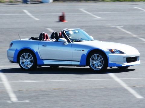 2001 Mercury Grand Marquis - A silver Honda S2000 convertible with blue trim is parked on a track with orange cones in the background.
