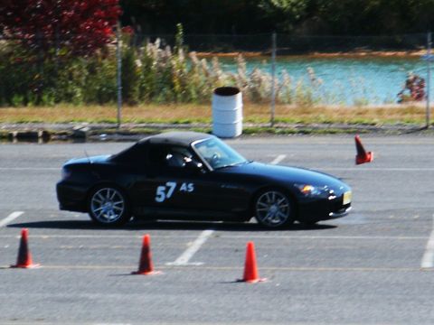 2001 Mercury Grand Marquis - A black convertible sports car navigates a course marked by orange cones.