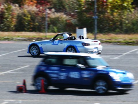 2001 Mercury Grand Marquis - Two cars compete on a track during an event, with autumn foliage visible in the background.