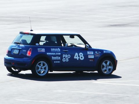 2001 Mercury Grand Marquis - A blue Mini Cooper, number 48, participates in a race with various sponsor decals on its body.