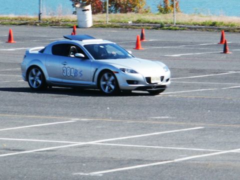 2001 Mercury Grand Marquis - A silver sports coupe navigates a course marked by orange cones on a paved lot.