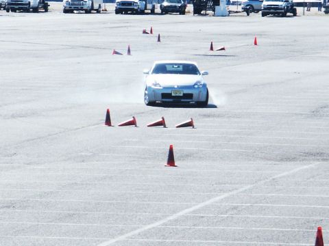 2001 Mercury Grand Marquis - A silver Nissan 350Z is seen on an autocross course, maneuvering around traffic cones.