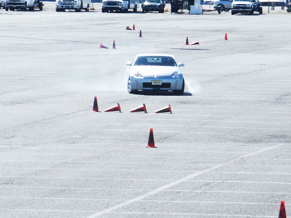 Silver Nissan 350Z navigating an autocross course with cones