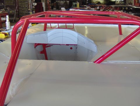 1978 Ford Bronco - A vehicle interior is shown with a prominent red roll cage and a white dashboard insert.