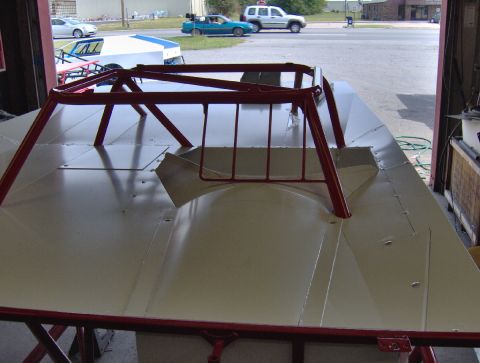 1978 Ford Bronco - A close-up view of a race car chassis with a prominent red roll cage.