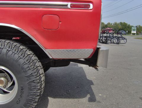 1978 Ford Bronco - Close-up of the rear side of a 1978 Ford Bronco, showing the tire and diamond plate accent.