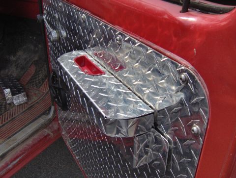 1978 Ford Bronco - Diamond plate covers the interior door panel of a 1978 Ford Bronco.