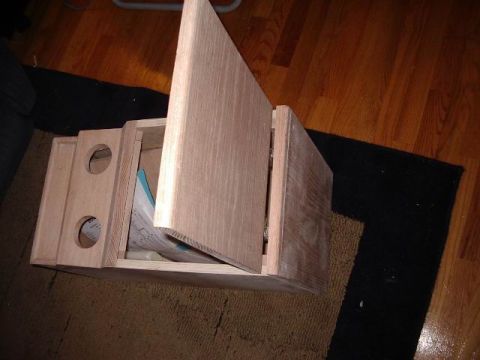 1985 Ford Bronco - A custom wooden center console is shown, with its lid open, revealing some papers inside.