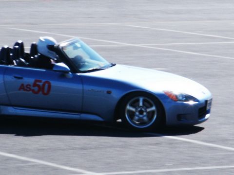 2001 Mercury Grand Marquis - A blue convertible sports car with racing numbers is on a track.