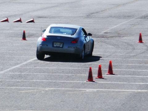 2001 Mercury Grand Marquis - A silver coupe is seen from the rear as it maneuvers through a course marked by orange traffic cones.