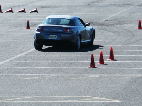 2001 Mercury Grand Marquis - Mazda RX-8 on a track with cones, likely during a performance driving event.