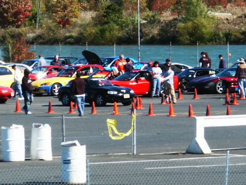 2001 Mercury Grand Marquis - A group of sports cars are gathered at what appears to be a racing event, with spectators observing.