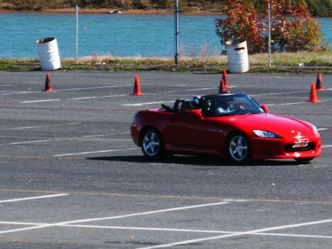 2001 Mercury Grand Marquis - A red convertible navigates a course marked by orange cones on a sunny day.