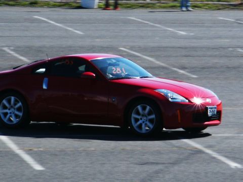 2001 Mercury Grand Marquis - A red sports car, possibly a Nissan 350Z, is seen on a track with racing number 281 displayed.