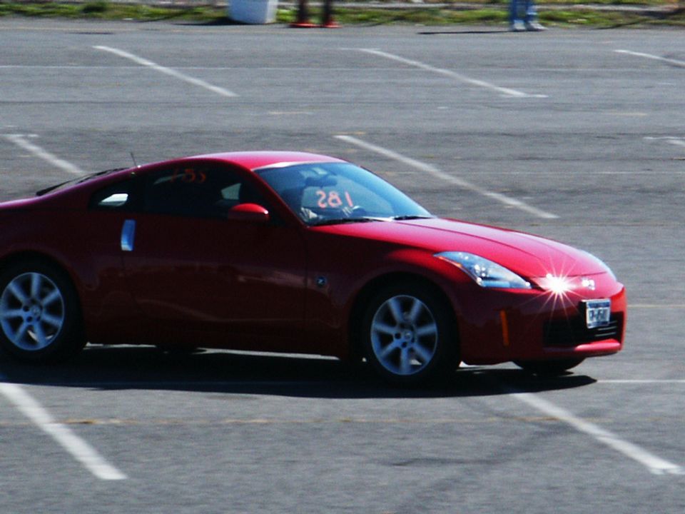 Red sports car with racing number 281 on windshield