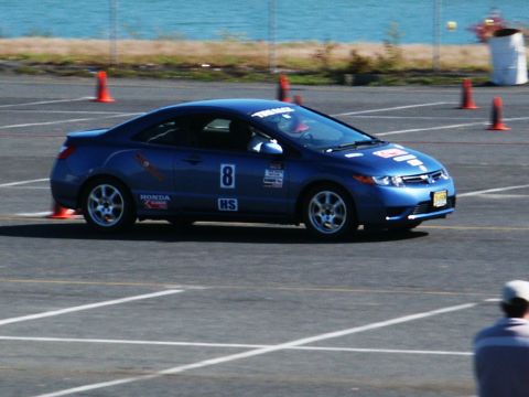 2001 Mercury Grand Marquis - A blue Honda Civic coupe is seen on a race track with orange cones marking the course.