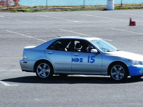 2001 Mercury Grand Marquis - Silver sedan with blue racing numbers on the door is parked on asphalt.