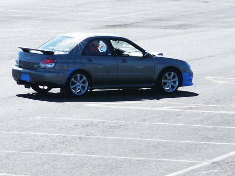 2001 Mercury Grand Marquis - A gray Subaru Impreza WRX sedan is seen from the side on a paved surface.