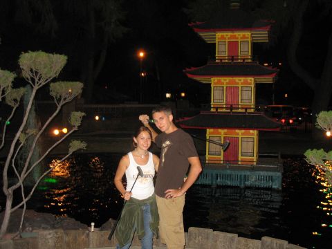 1997 Ford Probe - A couple poses for a photo at a miniature golf course at night, with a pagoda and water feature in the background.
