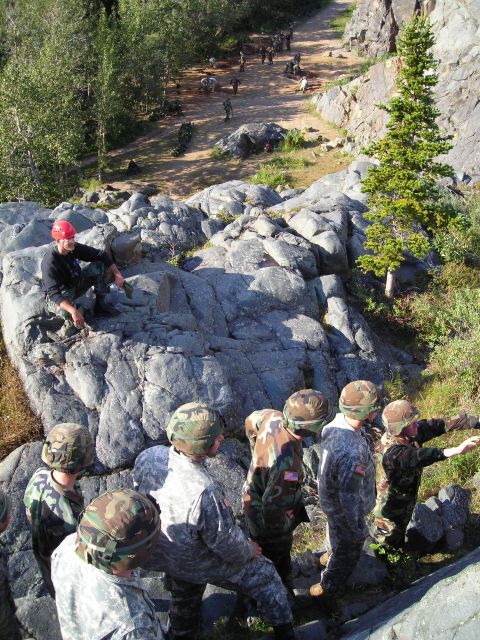 2003 Jeep TJ - A group of soldiers appears to be engaged in a training exercise on a , outdoor course.
