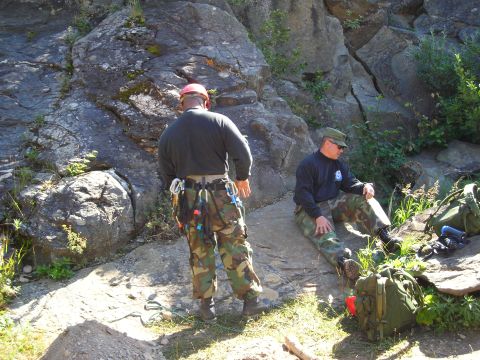 2003 Jeep TJ - Two individuals prepare for or rest from rock climbing activities in a natural, rocky environment.