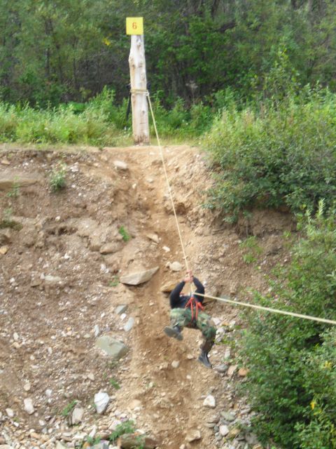 2003 Jeep TJ - A person descends a zipline course marked with a yellow sign displaying the number 6.