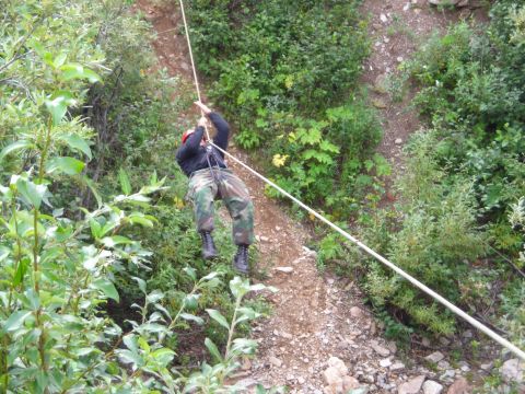 2003 Jeep TJ - A person descends a , vegetated slope using a rope for rappelling.