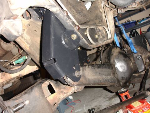 1996 Ford Bronco - Close-up of a lift kit bracket being installed on a vehicle's rear axle.