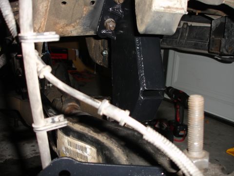 1996 Ford Bronco - A black metal bracket is welded onto the vehicle's frame, likely for a lift kit installation.