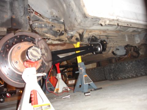 1996 Ford Bronco - Rear suspension and brake assembly of a 1996 Ford Bronco during a lift installation.