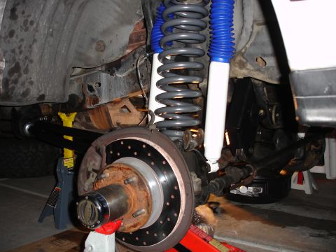 1996 Ford Bronco - New suspension components, including shocks and springs, are installed on a vehicle.