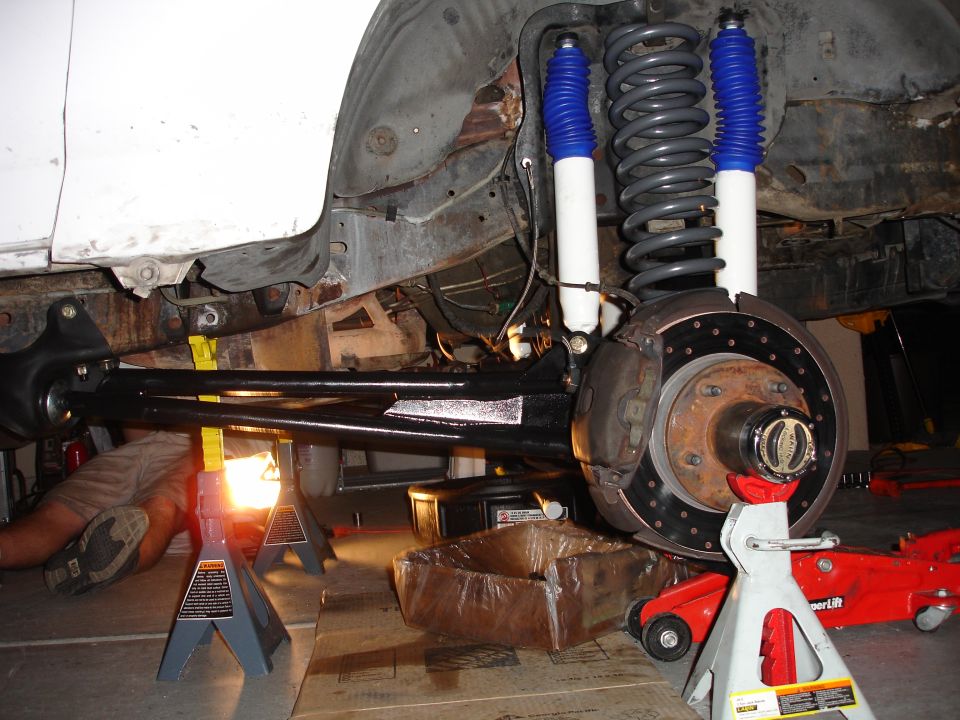 1996 Ford Bronco front suspension with new shocks and brake assembly visible