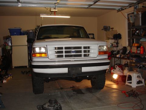 1996 Ford Bronco - Front view of a white 1996 Ford Bronco parked inside a garage.