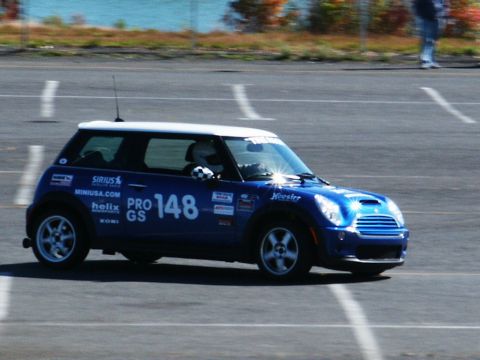 2001 Mercury Grand Marquis - A blue Mini Cooper with racing decals and number 148 is seen on a race track.