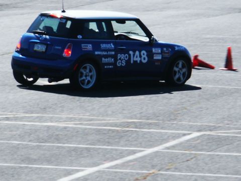 2001 Mercury Grand Marquis - A blue Mini Cooper with racing decals navigates a course marked by orange cones.