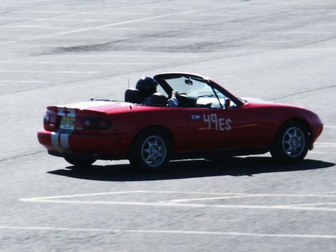 2001 Mercury Grand Marquis - A red convertible with racing stripes and numbers is parked on an asphalt surface.