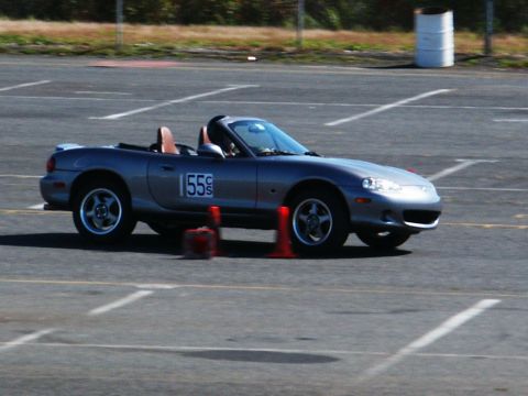 2001 Mercury Grand Marquis - A silver convertible sports car navigates a track, marked with racing number 155 and surrounded by cones.