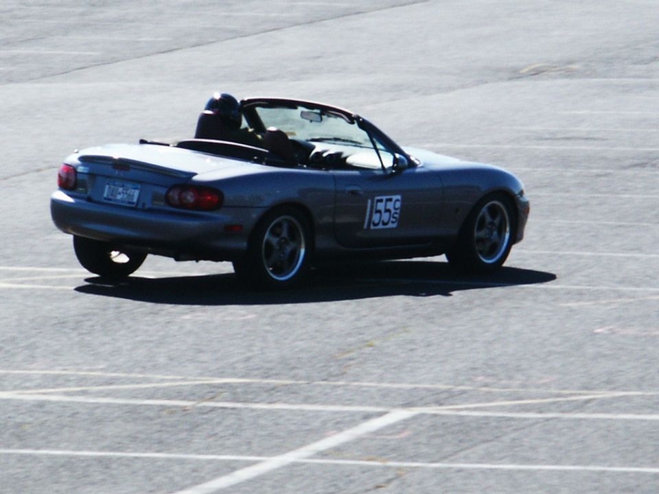 Silver convertible sports car with racing number 155 on the door