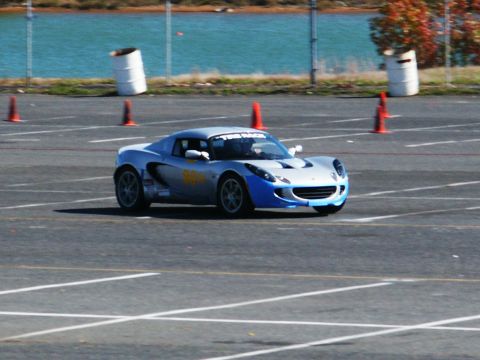 2001 Mercury Grand Marquis - A silver and blue sports car navigates a race track, marked with yellow decals and a windshield banner.
