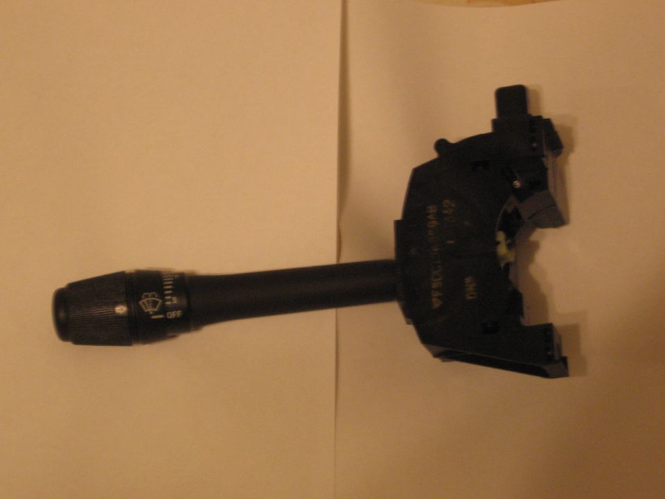Black turn signal/wiper control stalk switch on white paper background