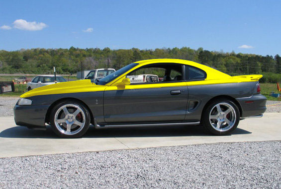 Two-tone gray and yellow coupe with aftermarket wheels and a hood scoop