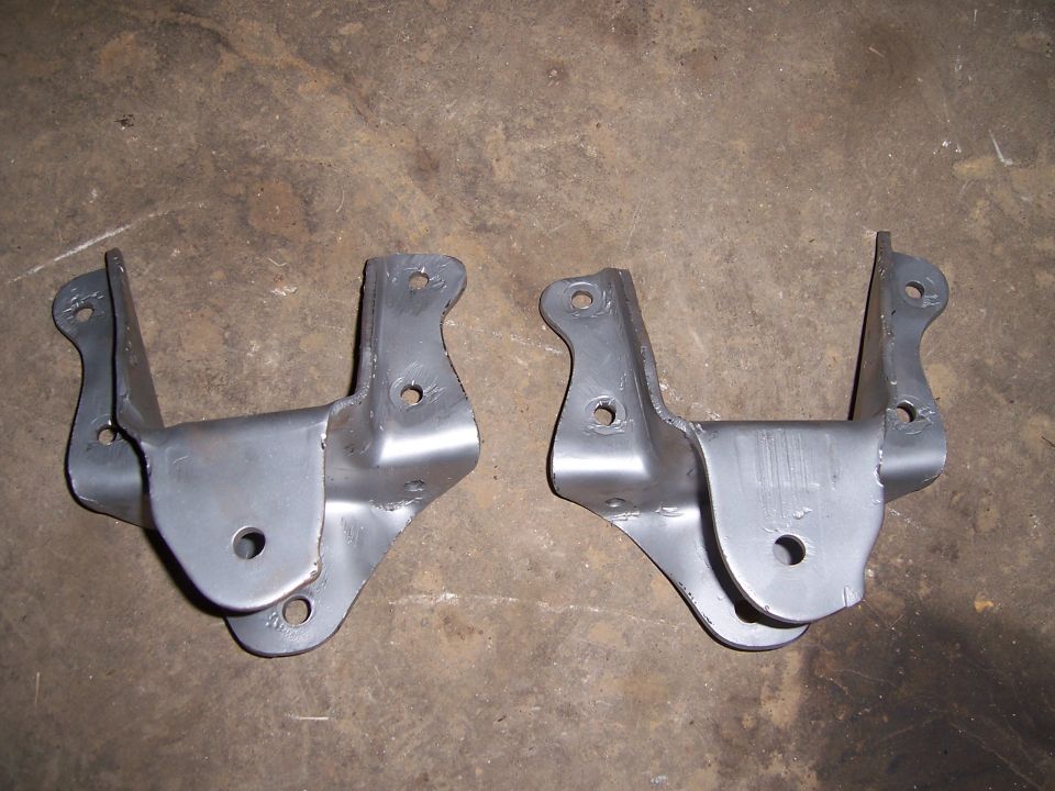 pair of metal suspension brackets on concrete floor