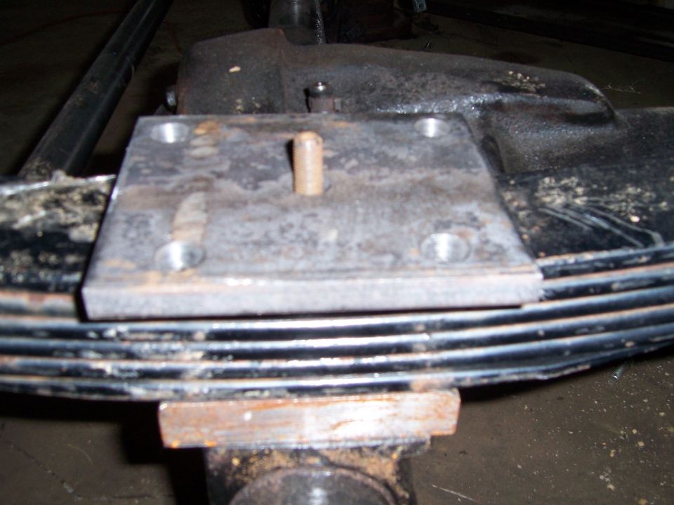 Leaf spring with bolted metal plate and pin