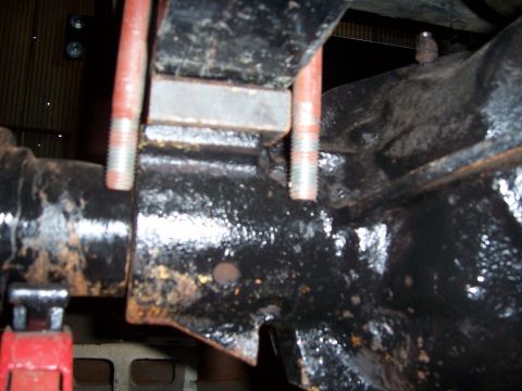 1983 Ford Bronco - Close-up view of a leaf spring U-bolt assembly connected to a vehicle's axle housing.