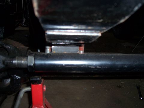 1983 Ford Bronco - Suspension component being worked on, supported by a red jack stand.