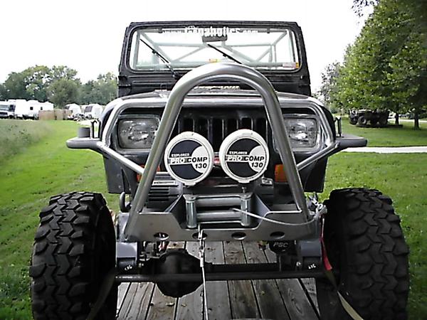 Black off-road 4x4 with tube bumper, Pro Comp lights and winch, front view