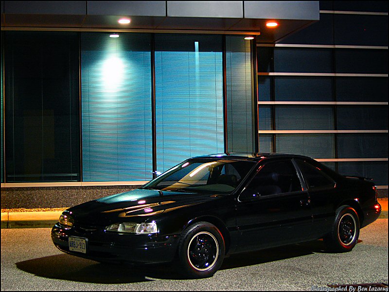 1997 Ford Thunderbird coupe parked outside a building at night
