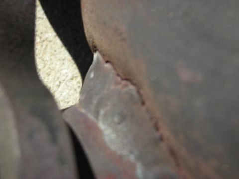 1992 Ford Crown Victoria - A detailed view of a weathered and rusty engine component, showing signs of age and wear.