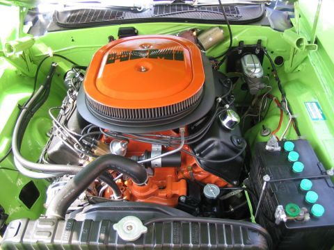 1993 Ford Taurus - Engine bay view of a vehicle with an orange air cleaner and bright green fenders, showing various engine components and a radiator.