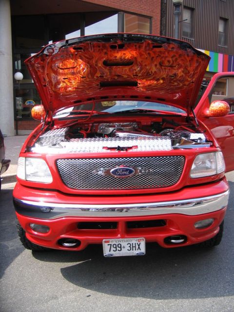 1993 Ford Taurus - This red Ford F-150 features custom flame graphics under the hood, seen at the Telephone City Car Show in 2006.